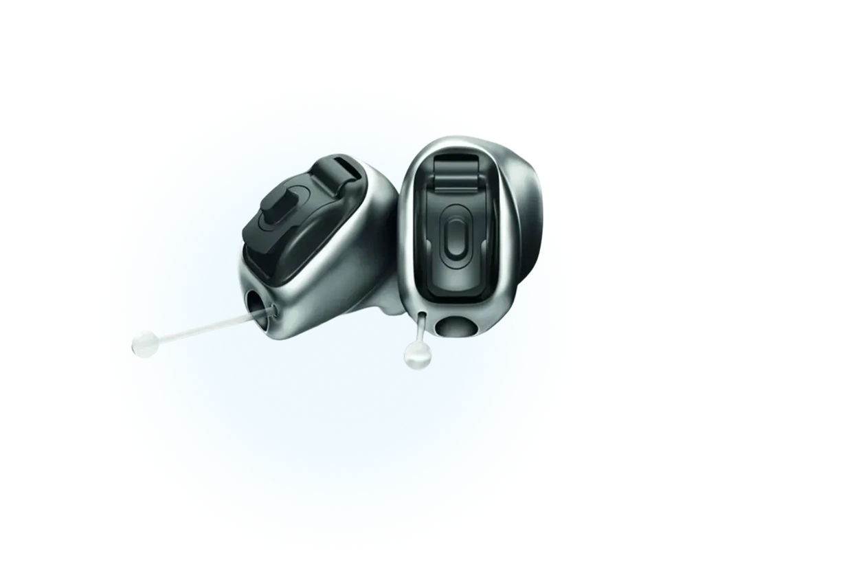 Sleek black and silver hearing aids on a blue background, showcasing modern design and technology.