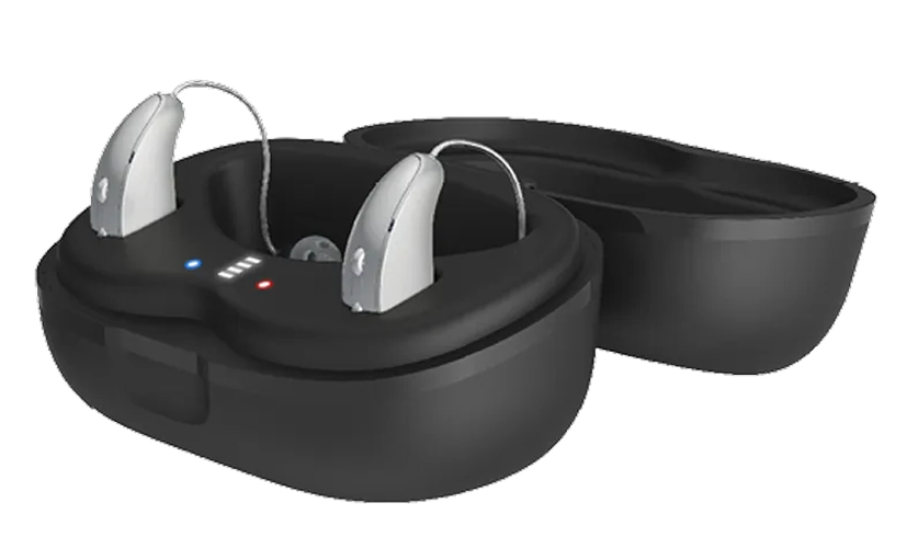 Silver hearing aids in a black charging case, showcasing modern design and functionality for improved hearing experience.