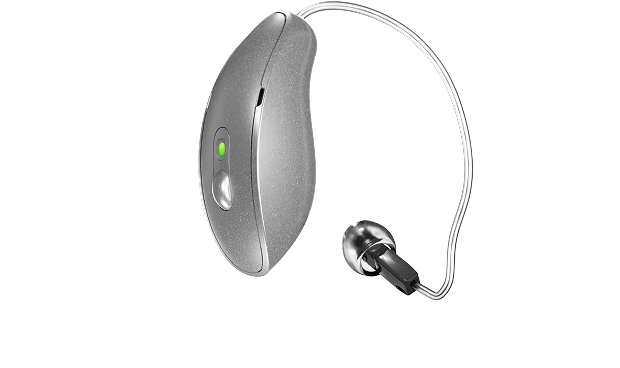 Modern silver hearing aid with small earbud and wire, featuring a green indicator light, isolated on white background.