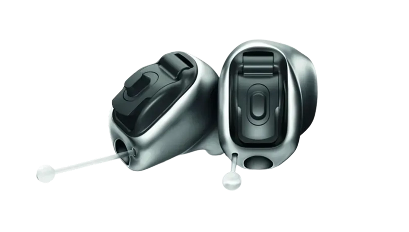 Compact, modern hearing aids with sleek black buttons and discreet design, ideal for enhanced auditory experience.