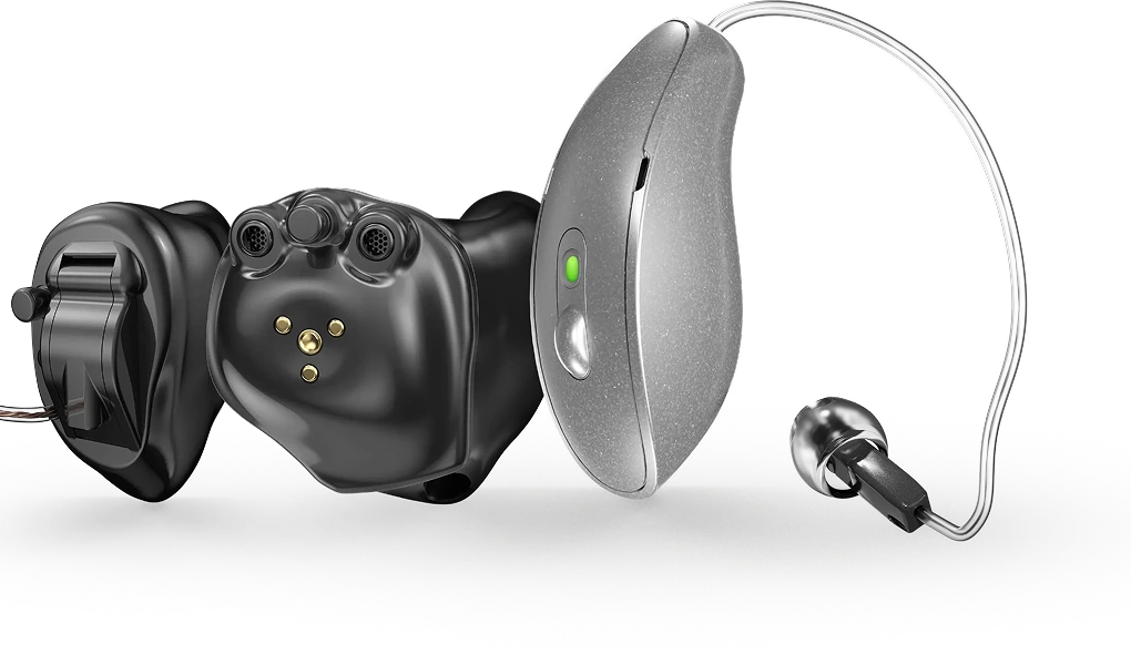 Modern black and silver hearing aids with advanced technology, close-up view.