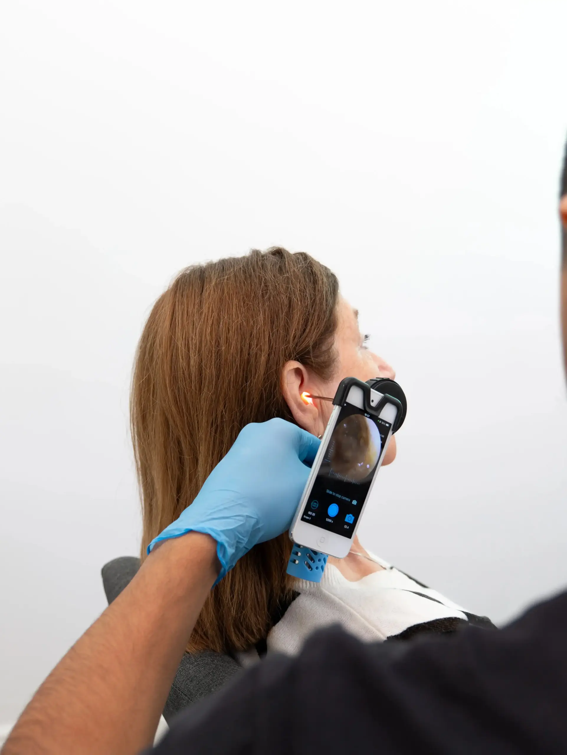 Professional ear examination using an otoscope camera to check a patient’s ear